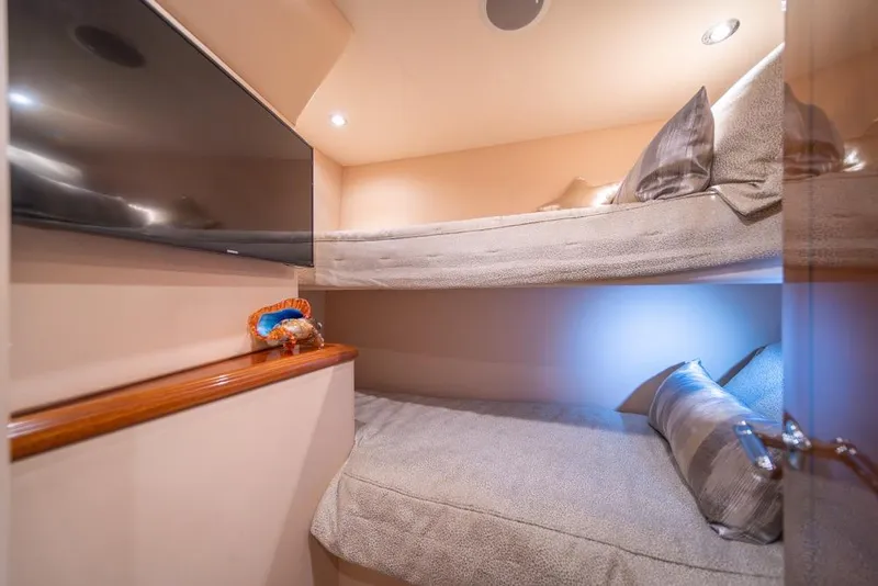 Slide: The Image of Bunk beds in 2008 Hatteras 72 Motor Yacht cabin, featuring cozy lighting and modern decor. - 47