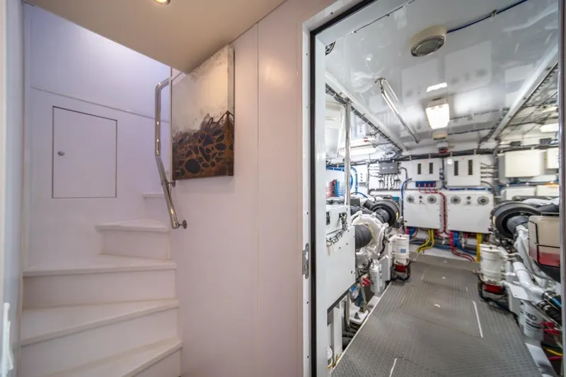 Slide: The Image of Engine room of 2008 Hatteras 72 Motor Yacht with visible machinery and stairway. - 48