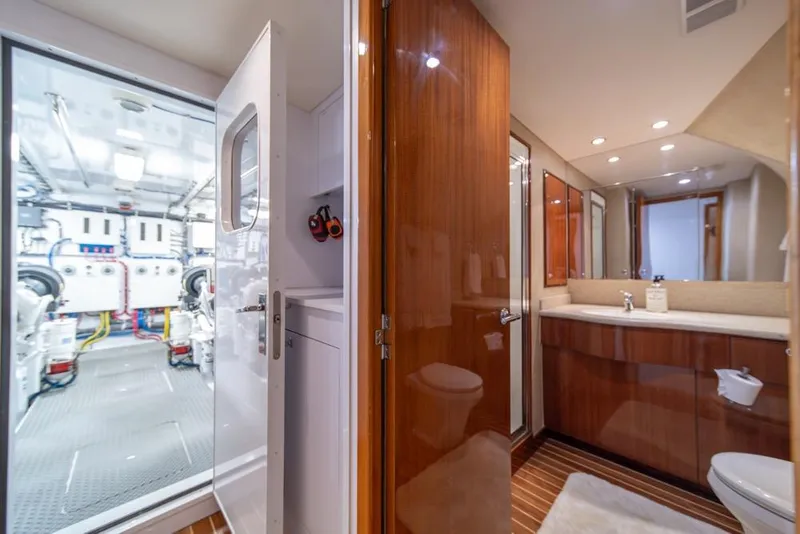 Slide: The Image of Luxurious 2008 Hatteras 72 Motor Yacht interior with engine room and bathroom view. - 49