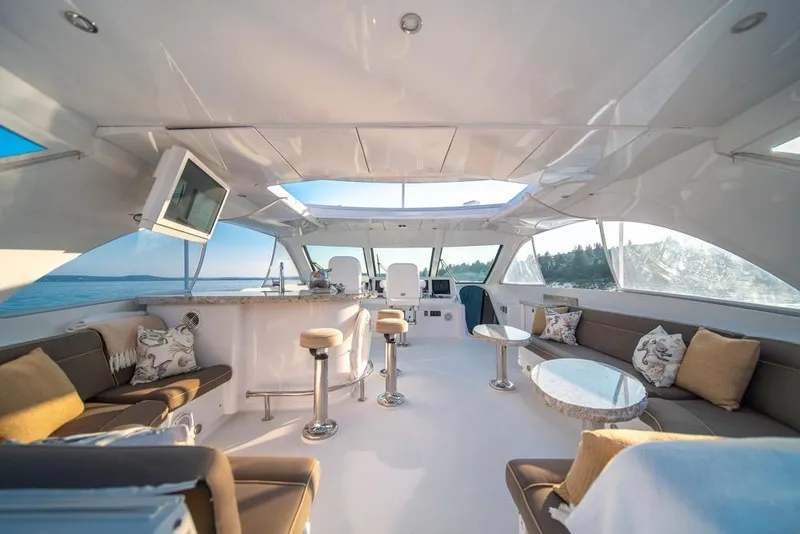 Slide: The Image of Luxurious interior of a 2008 Hatteras 72 Motor Yacht with elegant seating and panoramic windows. - 9