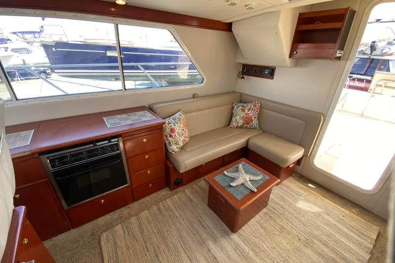 Slide: The Image of Luxurious 2003 Zeta 36 yacht interior with cozy seating and elegant wooden cabinetry. - 11