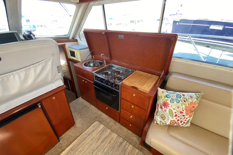 Slide: The Image of Interior of 2003 Zeta 36 boat with kitchen and seating area. - 14