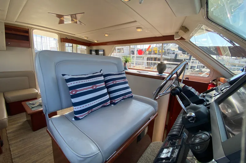 Slide: The Image of Interior of 2003 Zeta 36 yacht with helm, striped cushions, and nautical decor. - 29