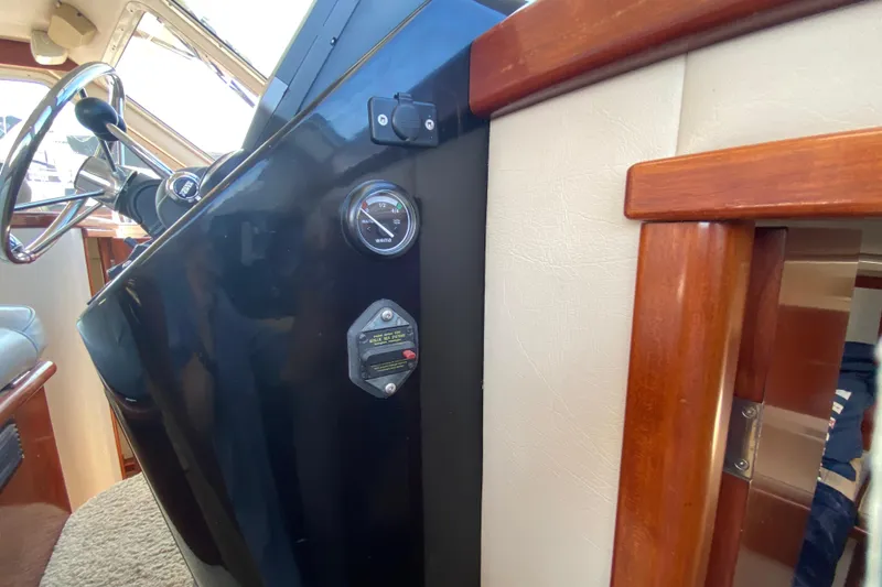 Slide: The Image of Interior view of a 2003 Zeta 36 boat dashboard with steering wheel and gauges. - 30