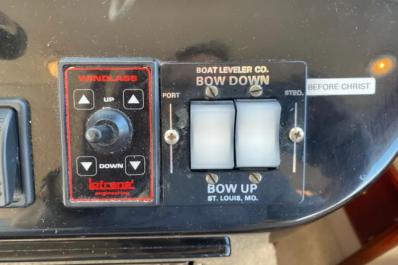 Slide: The Image of Control panel of a 2003 Zeta 36 boat with windlass and bow leveler switches. - 34