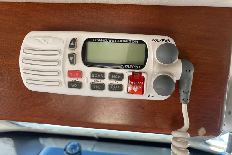 Slide: The Image of VHF marine radio on wooden panel, Standard Horizon Intrepid+ model, Zeta 36, 2003. - 38