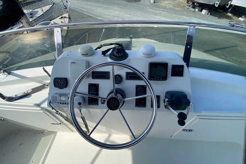 Slide: The Image of Helm of 2003 Zeta 36 boat with steering wheel and navigation instruments. - 49