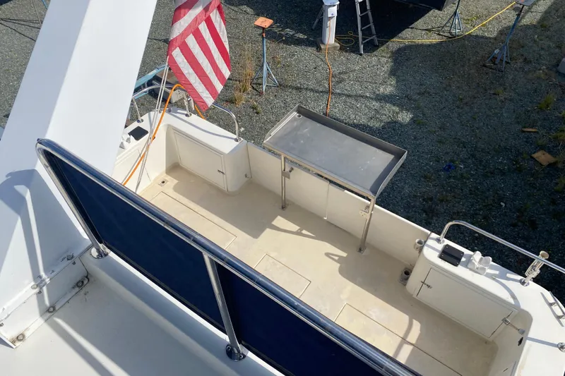 Slide: The Image of 2003 Zeta 36 boat deck with American flag and stainless steel table. - 56