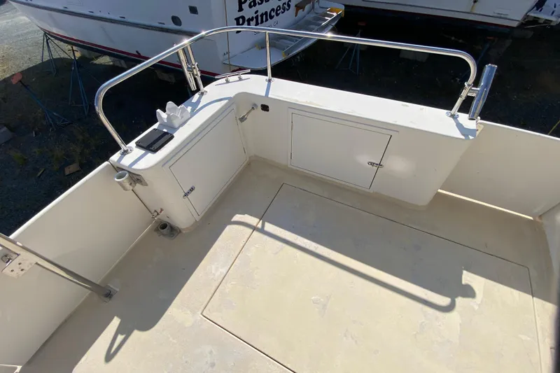 Slide: The Image of Zeta 36 boat deck, 2003 model, featuring storage compartments and railing. - 61