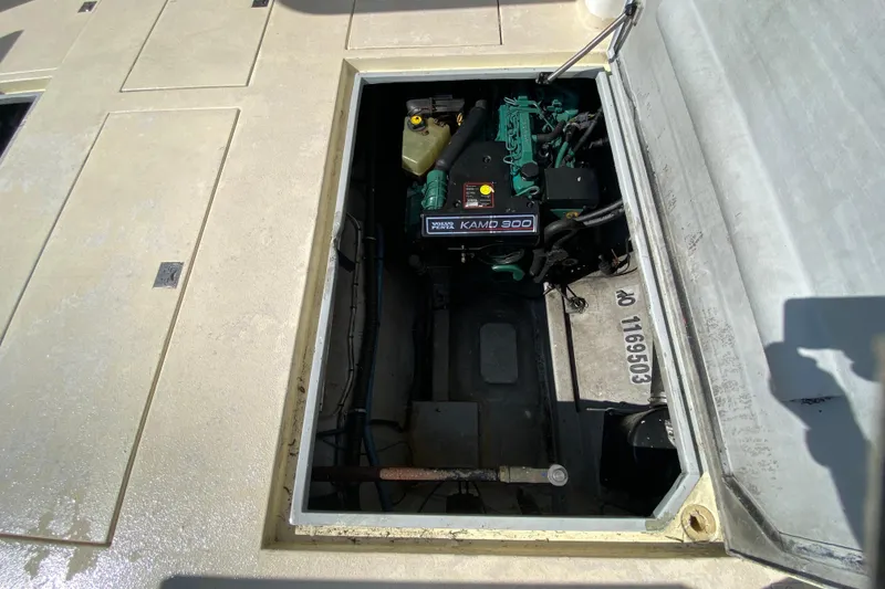 Slide: The Image of Engine compartment of a 2003 Zeta 36 boat, featuring a KAMD 300 engine. - 63