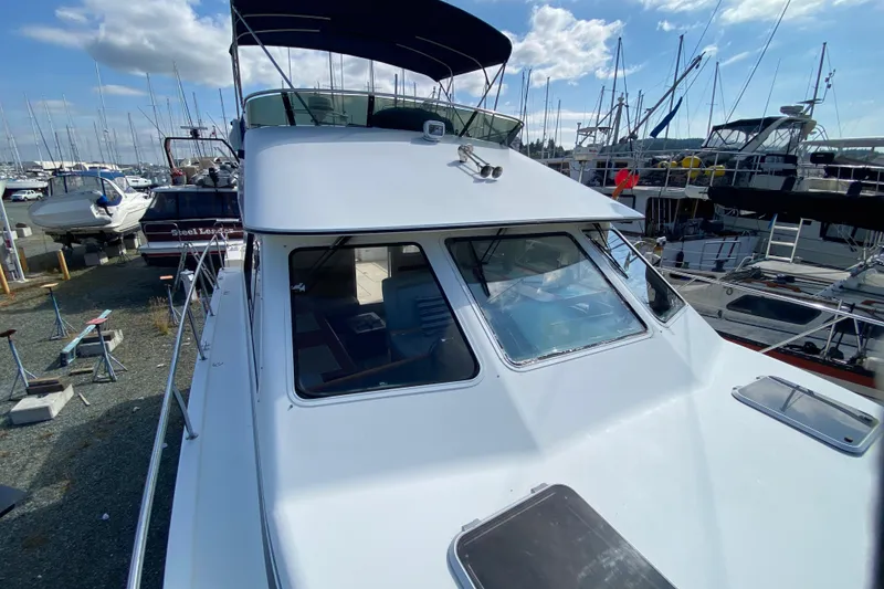 Slide: The Image of 2003 Zeta 36 yacht docked at marina under clear blue sky. - 69