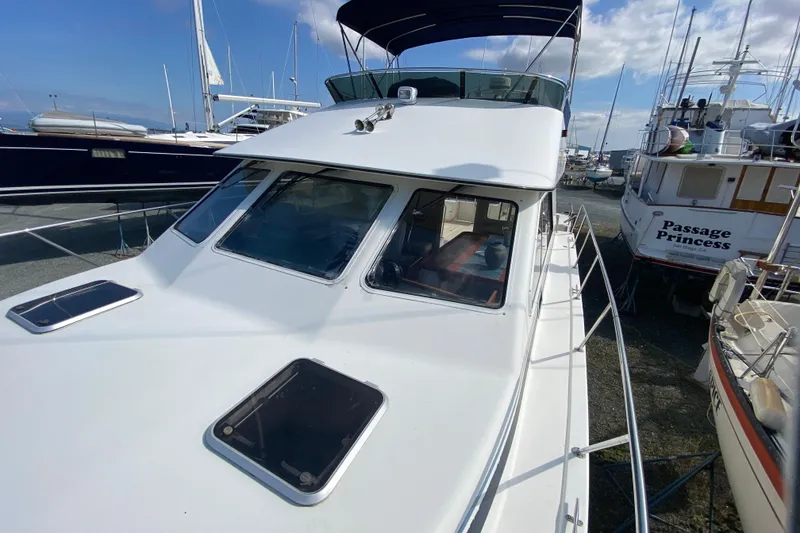 Slide: The Image of 2003 Zeta 36 boat docked, featuring sleek design and spacious deck area. - 70