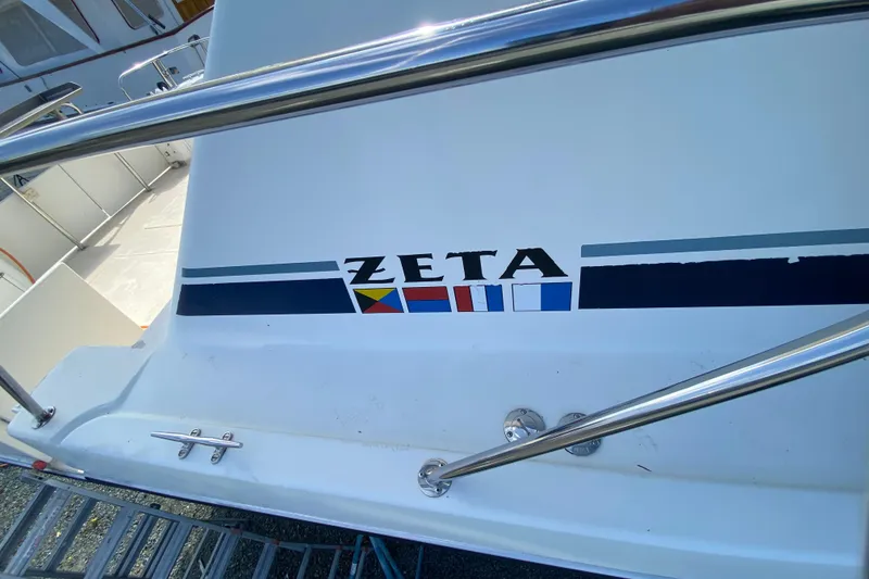 Slide: The Image of 2003 Zeta 36 boat with nautical flags and chrome railings. - 73
