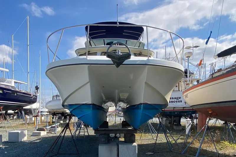 Slide: The Image of 2003 Zeta 36 boat on stands in a marina, surrounded by other vessels. - 74