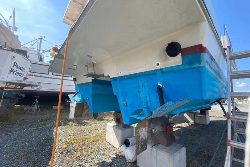 Slide: The Image of Boat on dry dock, Zeta 36 model, 2003, with visible propeller and blue hull. - 78