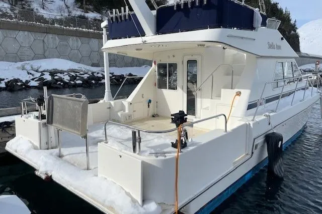 Slide: The Image of 2003 Zeta 36 boat docked in snowy marina, rear view. - 83