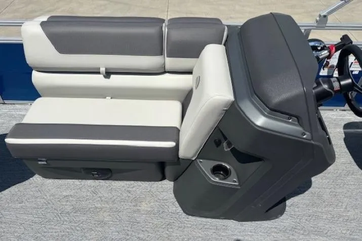 Slide: The Image of 2026 Sun Tracker Fishin' Barge 20 DLX boat seating and console, featuring gray and white upholstery. - 10
