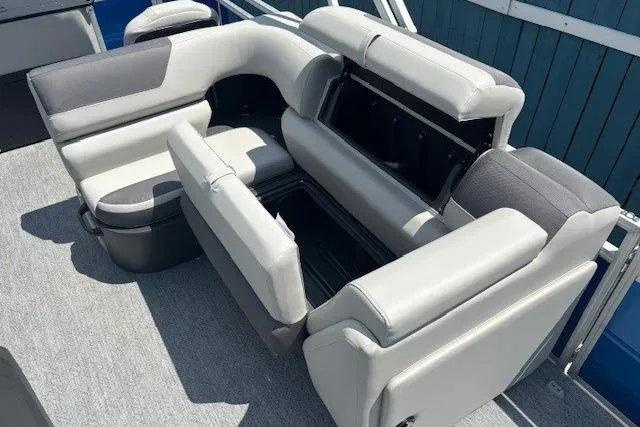 Slide: The Image of 2026 Sun Tracker Fishin' Barge 20 DLX seating with storage compartments, gray upholstery. - 14