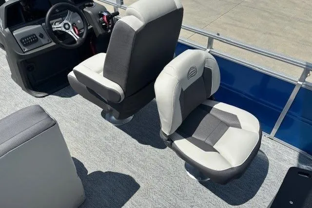 Slide: The Image of 2026 Sun Tracker Fishin' Barge 20 DLX interior with comfortable seating and steering console. - 22
