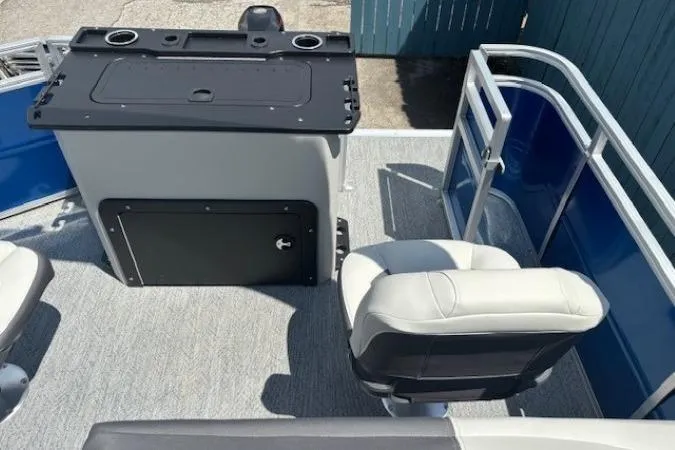 Slide: The Image of 2026 Sun Tracker Fishin' Barge 20 DLX interior with seating and control panel. - 23