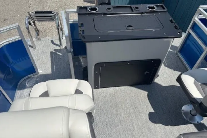 Slide: The Image of 2026 Sun Tracker Fishin' Barge 20 DLX interior with seating and control panel. - 25