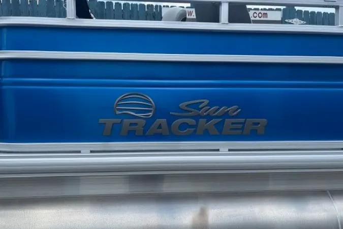 Slide: The Image of 2026 Sun Tracker Fishin' Barge 20 DLX, blue exterior with logo detail. - 4