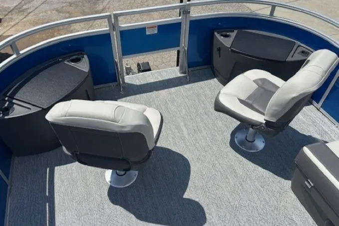 Slide: The Image of 2026 Sun Tracker Fishin' Barge 20 DLX interior with swivel seats and storage compartments. - 8
