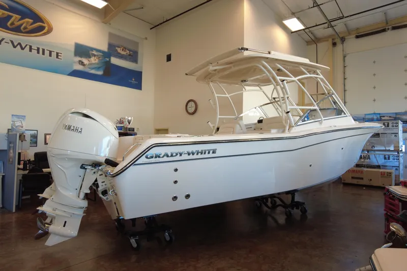 The Image of 2025 Grady-White Freedom 275 boat displayed indoors with Yamaha engine. - 1