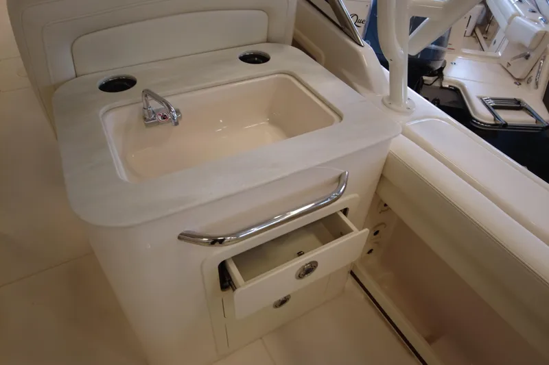Slide: The Image of Luxury sink and storage on 2025 Grady-White Freedom 275 boat interior. - 4