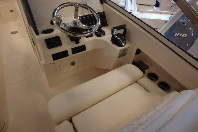 Slide: The Image of 2025 Grady-White Freedom 275 boat cockpit with steering wheel and controls. - 5