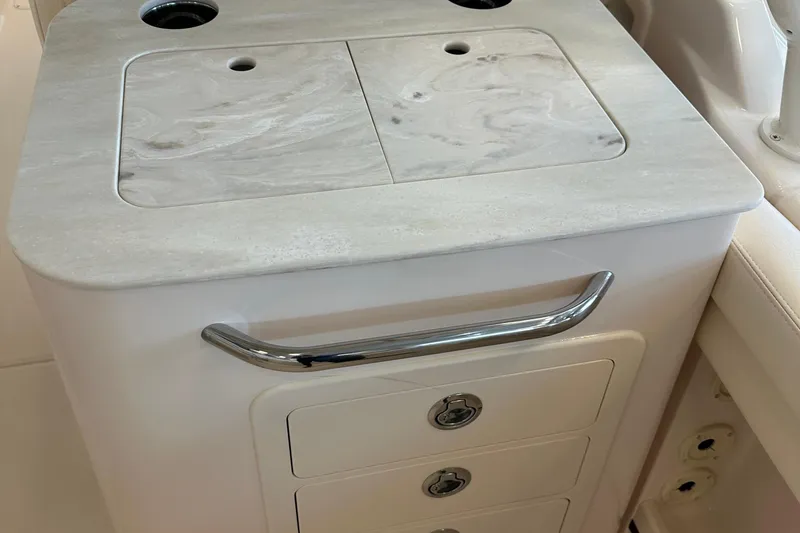 Slide: The Image of 2025 Grady-White Freedom 275 boat interior with sleek countertop and storage drawers. - 8
