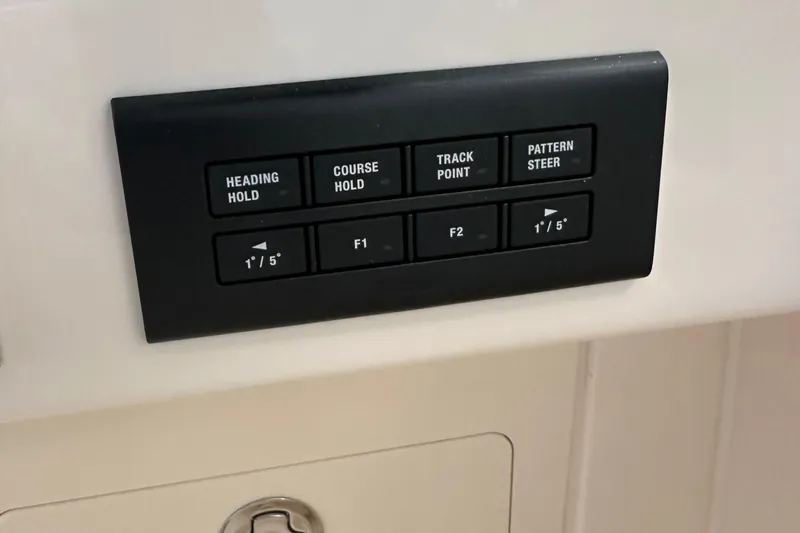 Slide: The Image of Control panel on 2025 Grady-White Freedom 275 boat with navigation buttons. - 9