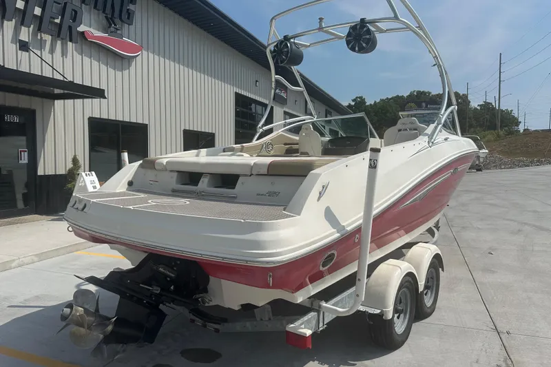 Slide: The Image of 2007 Sea Ray 230 Select boat on trailer outside a marine dealership. - 1