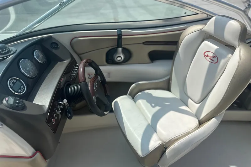 Slide: The Image of 2007 Sea Ray 230 Select boat interior with steering wheel and captain's chair. - 10