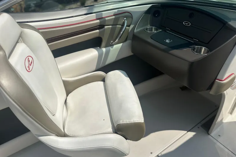 Slide: The Image of Interior of a 2007 Sea Ray 230 Select boat with white seating and dashboard. - 11