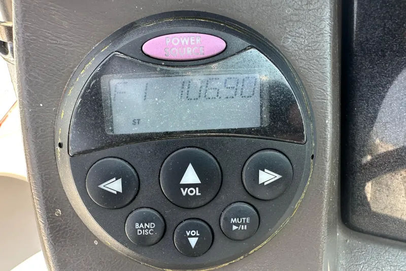 Slide: The Image of Control panel of a 2007 Sea Ray 230 Select boat, displaying FM radio frequency. - 16