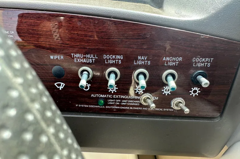 Slide: The Image of Control panel of a 2007 Sea Ray 230 Select boat with various switches. - 17