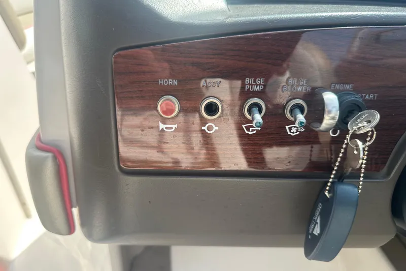 Slide: The Image of Control panel of a 2007 Sea Ray 230 Select boat with switches and keys. - 18