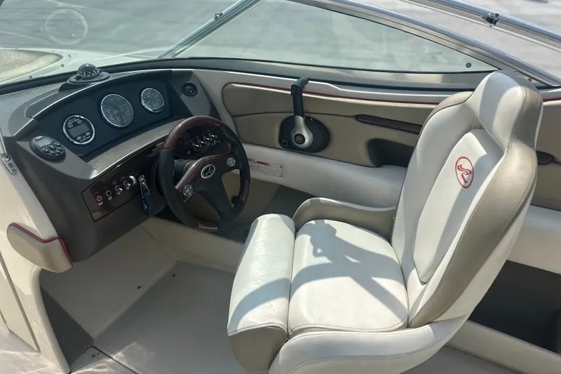 Slide: The Image of 2007 Sea Ray 230 Select boat interior with steering wheel and dashboard controls. - 8