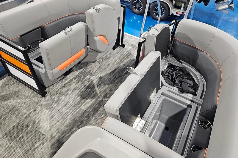 Slide: The Image of 2026 Bentley Pontoons Bolt interior with gray and orange seating, storage compartments, and cup holders. - 19