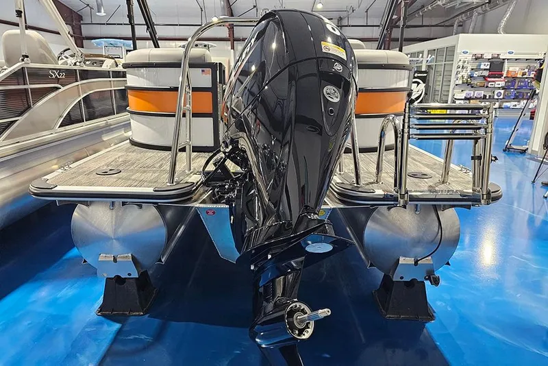 Slide: The Image of 2026 Bentley Pontoons Bolt with powerful outboard motor in showroom display. - 5