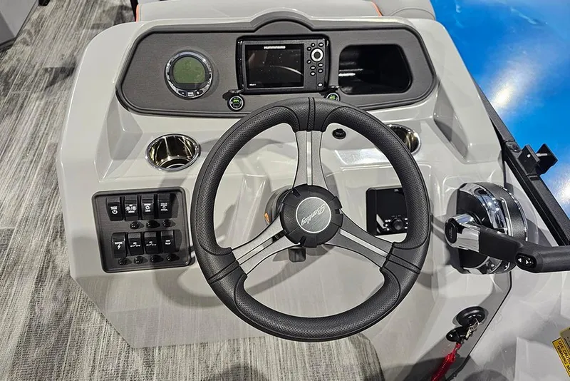 Slide: The Image of 2026 Bentley Pontoons Bolt dashboard with steering wheel, controls, and navigation display. - 9