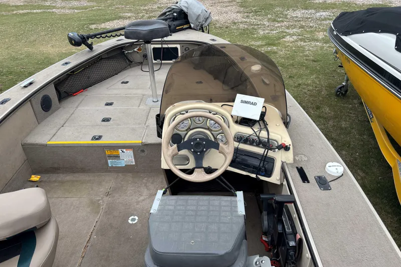 Slide: The Image of 2001 Alumacraft Tournament Pro 185 CS boat interior with steering wheel and Simrad electronics. - 3