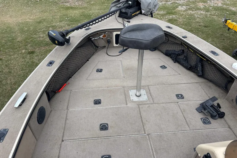 Slide: The Image of 2001 Alumacraft Tournament Pro 185 CS boat interior with seating and storage compartments. - 4