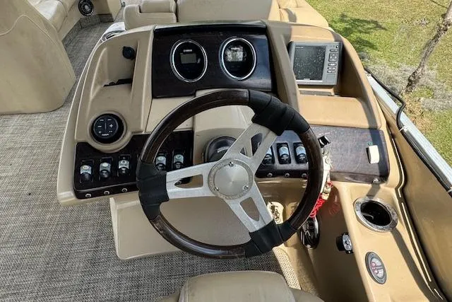 Slide: The Image of 2016 Bennington 2575 RCW boat dashboard with steering wheel and control panel. - 11