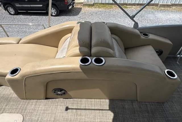 Slide: The Image of 2016 Bennington 2575 RCW boat interior with beige seating and cup holders. - 12