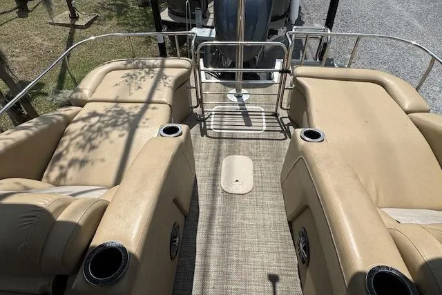 Slide: The Image of 2016 Bennington 2575 RCW boat interior with beige seating and cup holders. - 13