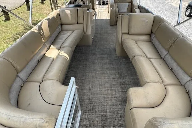 Slide: The Image of 2016 Bennington 2575 RCW pontoon boat with spacious beige seating and carpeted deck. - 6