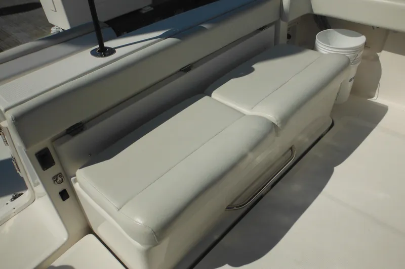 Slide: The Image of 2001 Tiara Yachts 3500 Open interior seating with white upholstery and storage. - 11