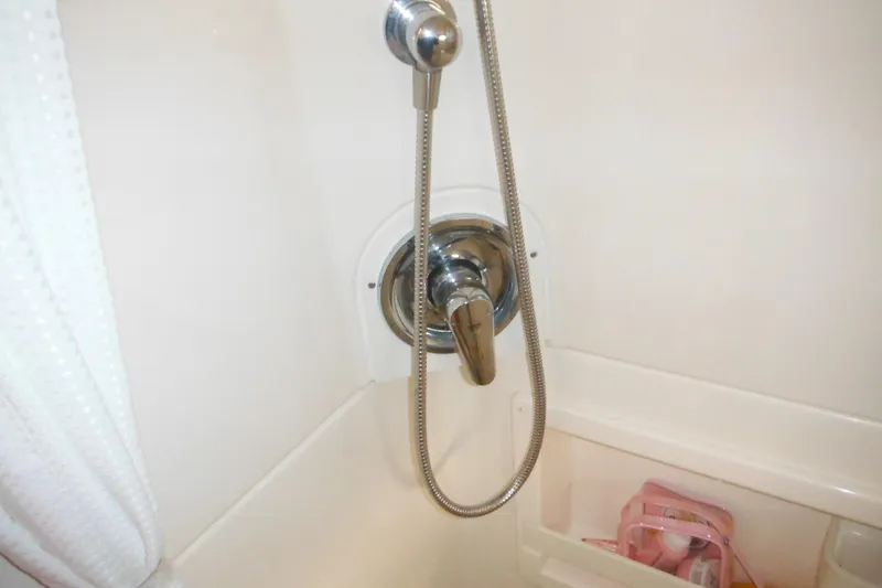 Slide: The Image of Shower area in 2001 Tiara Yachts 3500 Open, featuring chrome fixtures and storage. - 112